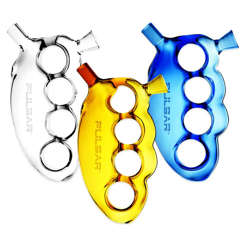 Pulsar's Knuckle Bubbler. A 5.5-inch glass pipe shaped as brass knuckles. Herb bowl over your index finger, mouthpiece under your index finger.