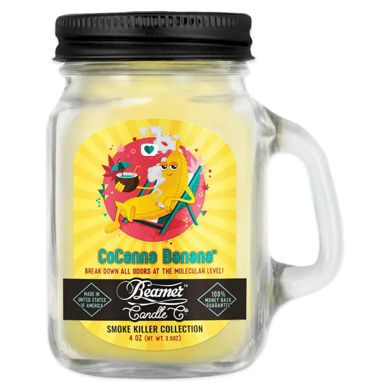 Beamer Candle co's 4oz candle in the CoCanna Banana scent. Pale yellow wax, reusable glass mason jar with a metal lid. The Beamer branded sticker features a banana sitting out on a beach chair drinking a pina colada.