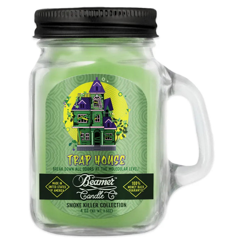 Beamer Candle Co's 4oz candle in a Trap House scent. Light green wax, reusable glass mason jar with metal lid. The Beamer branded sticker features a run-down green haunted house.