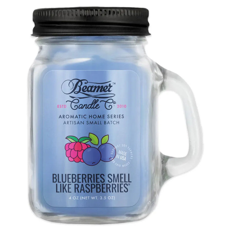 Beamer Candle Co's 4oz candle in the Blueberries Smell Like Raspberries scent. Light blue wax, reusable glass mason jar with lid. The Beamer branded sticker features one raspberry and two blueberries next to each other.