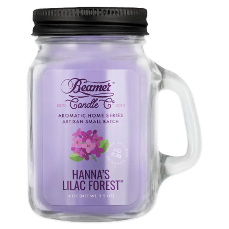 Beamer Candle Co's 4oz candle in a Hanna's Lilac Forest scent. Lavender coloured wax, reusable glass mason jar with lid. The Beamer branded sticker features a bunch of fresh lilacs.