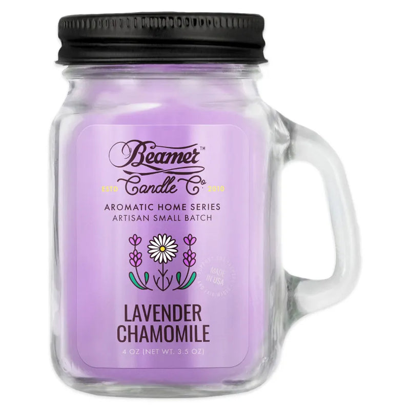 Beamer Candle Co's 4oz candle in a Lavender Chamomile scent. Lavender coloured wax, reusable glass mason jar with metal lid. The Beamer branded sticker features two lavenders with a daisy in between.