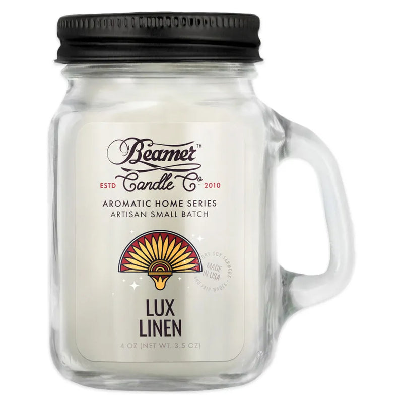 Beamer Candle Co's 4oz candle in a Lux Linen scent. Gray wax, reusable glass mason jar with metal lid. The Beamer branded sticker features a hand-fan that is fanned out with dark red and yellow accents.