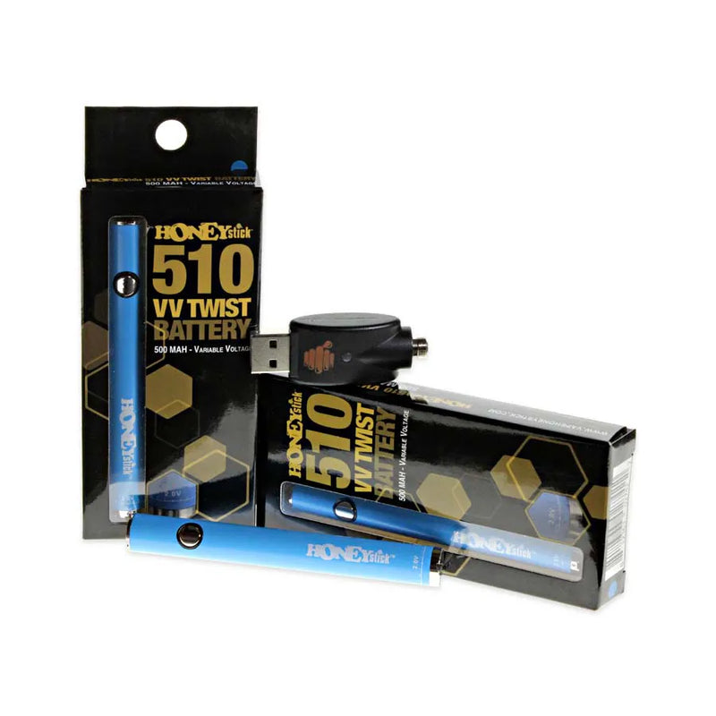 Honeystick's 510 thread blue vape cartridge battery. Laying next to two display boxes that showcase the retail packaging and the usb charger sits on top.