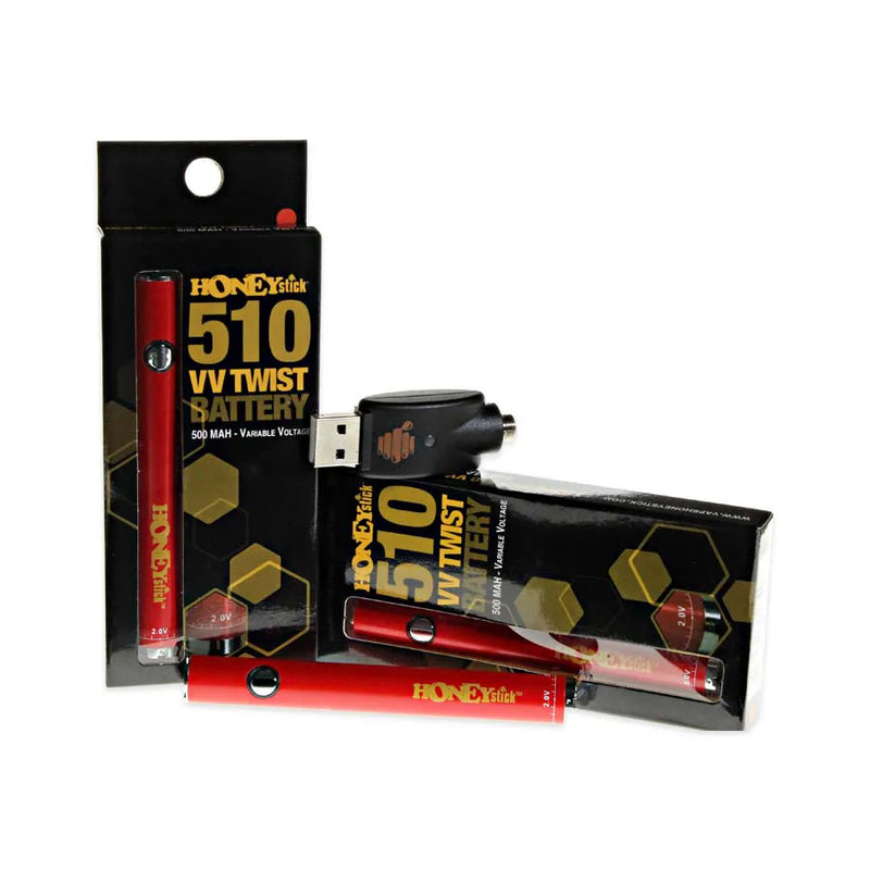 Honeystick's 510 thread red vape cartridge battery. Laying next to two display boxes that showcase the retail packaging and the usb charger sits on top.