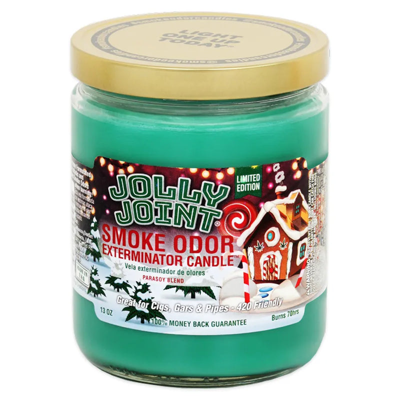 Smoke Odor's 13oz candle in a jolly joint scent. Green coloured wax, gold lid, glass jar. The Smoke Odor branded sticker features a gingerbread house, snowfall, candy canes, and various pine trees.