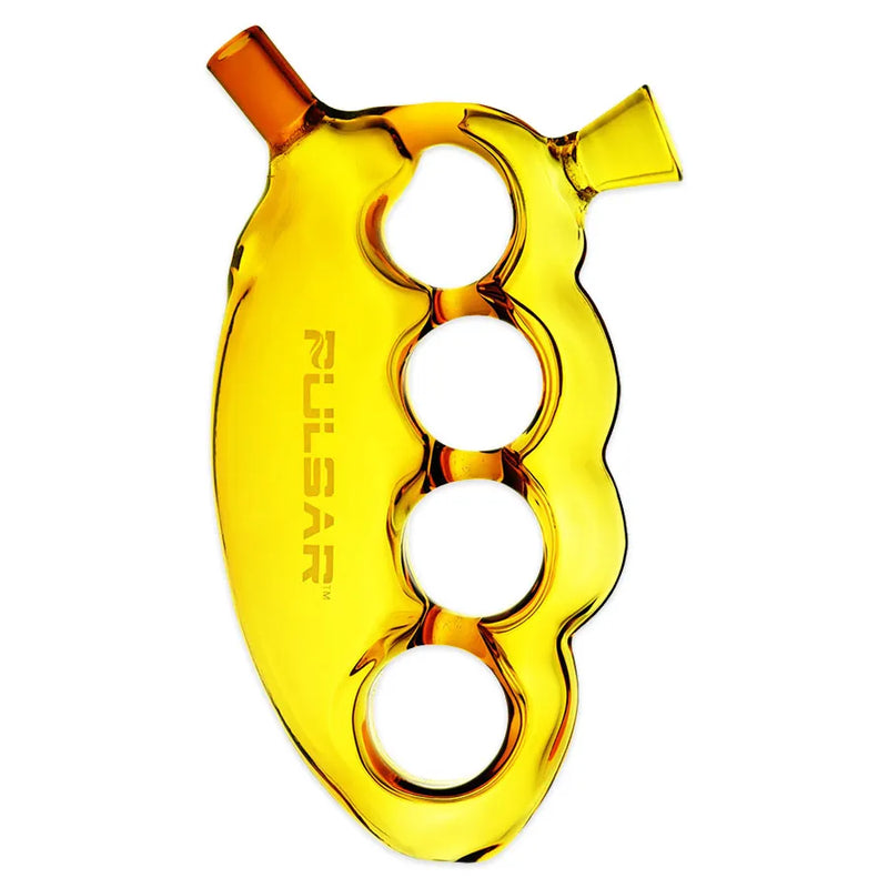 Pulsar's Knuckle Bubbler. A 5.5-inch glass pipe shaped as brass knuckles. Herb bowl over your index finger, mouthpiece under your index finger. Gold colour.