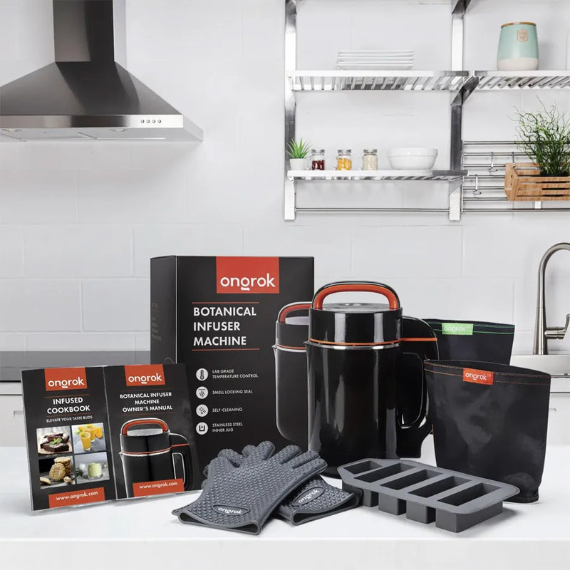 Ongrok's small botanical infuser machine and kit. Showcasing a spread of the large machine, a infused cookbook, owners manual, oven gloves, two storage bags, and molds.