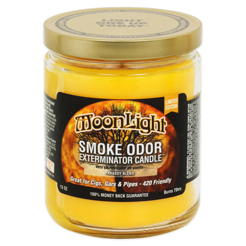 Smoke Odor's 13oz Exterminator Candle in the MoonLight scent. A deep yellow almost orange wax colour with a gold lid. The sticker label features an orange moon with a black tree silhouette over top of it.