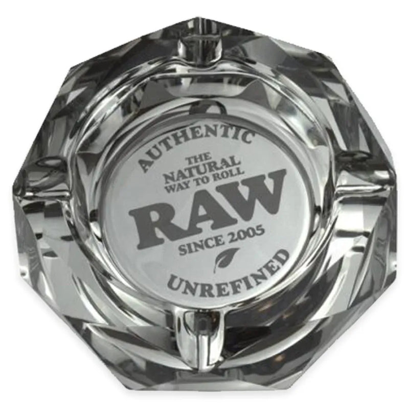 RAW's Dark Side Glass Ashtray. A dark gray glass ashtray in a crystal like construction. Authentic RAW branding in the middle.