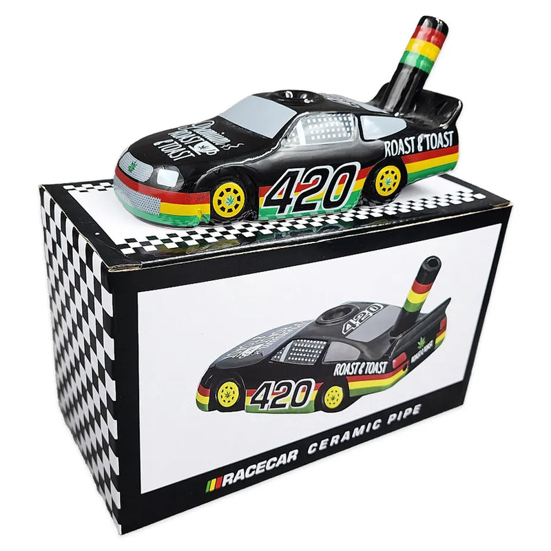 A ceramic race car smoking adorned with 420 Rasta accents on top of its display box.