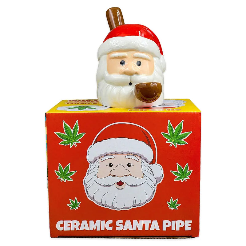 A smoking pipe made of ceramic shaped as Santa Claus's Head on top of its display box.