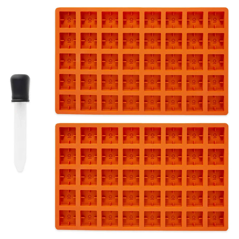 Ongrok's scored silicone gummy molds. Two orange molds and 1 dropper.