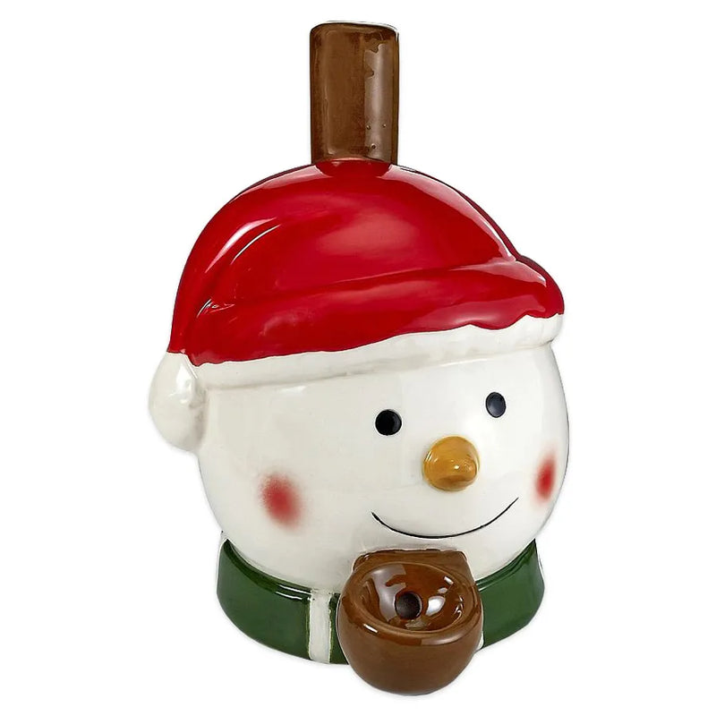 A ceramic smoking pipe that looks like a snowmans head wearing a santa hat and a green scarf.