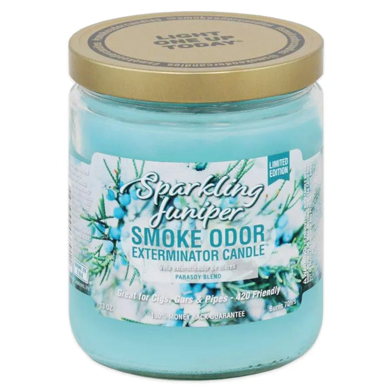 Smoke Odor's 13oz jar candle in a sparkling juniper scent. Light blue coloured wax, gold lid, glass jar. Smoke Odor branded sticker features a frost covered juniper.