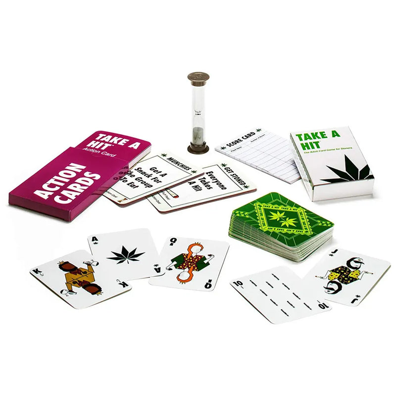 The Take A Hit Card Game. Showcasing the box the cards come in, the deck, action cards, score cards, and an hourglass. All of the decks and different cards are splayed out across the image.