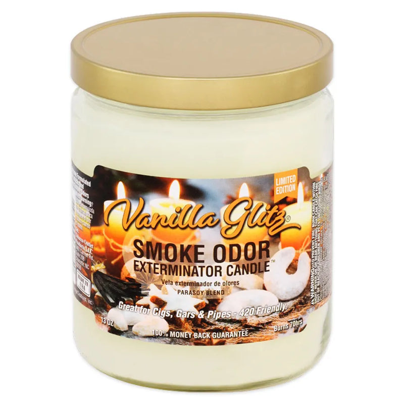 Smoke Odor's 13oz jar candle in a vanilla glitz scent. Off-white beige coloured wax, gold lid, glass jar. The Smoke Odor branded sticker features various lit candles, vanilla beans, and various fall themed table accessories.